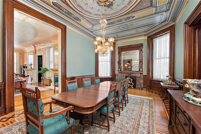 dining space featuring a chandelier, a raised ceiling, and ornamental molding