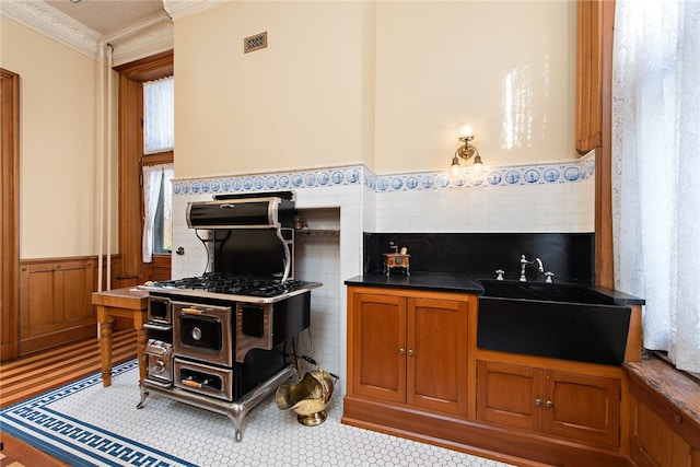 interior space featuring tile walls and ornamental molding