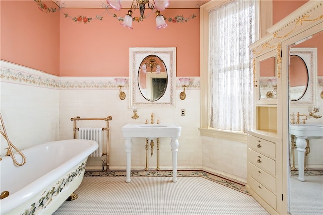 bathroom with a bath to relax in, tile walls, tile floors, and radiator