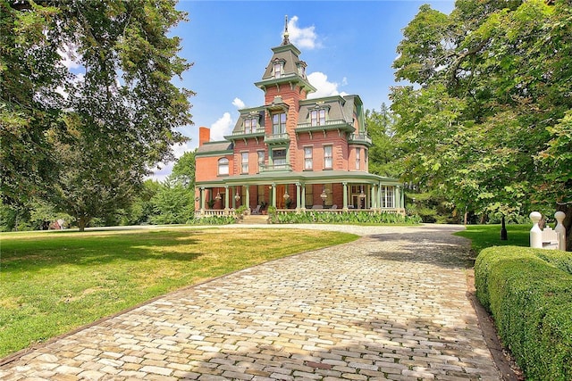 italianate home featuring a porch and a front lawn