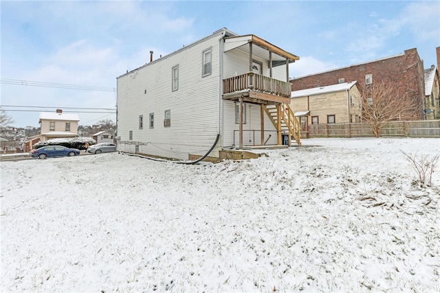 view of snow covered rear of property