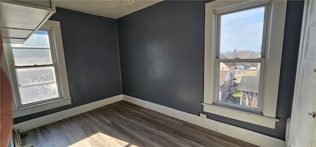 spare room with dark hardwood / wood-style flooring