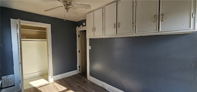 interior space featuring white cabinetry, dark hardwood / wood-style floors, and ceiling fan