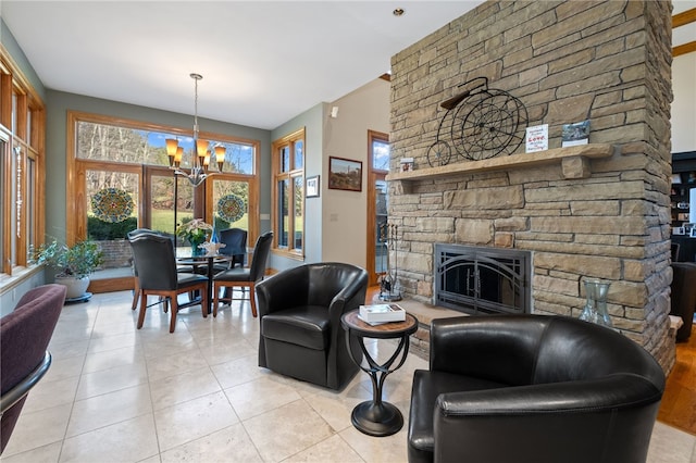 tiled living room featuring an inviting chandelier and a fireplace