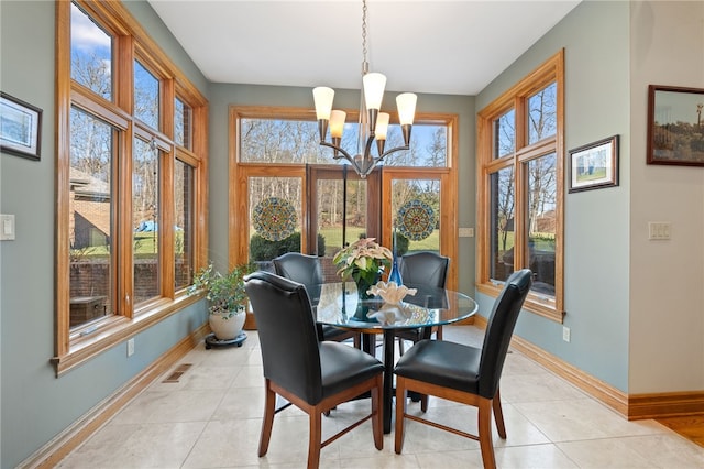 tiled dining area with an inviting chandelier