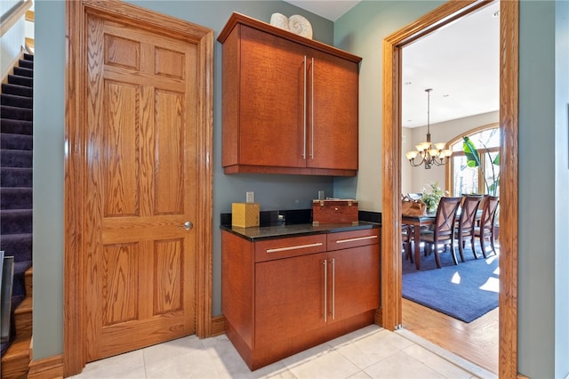 interior space featuring an inviting chandelier, pendant lighting, and light tile patterned flooring