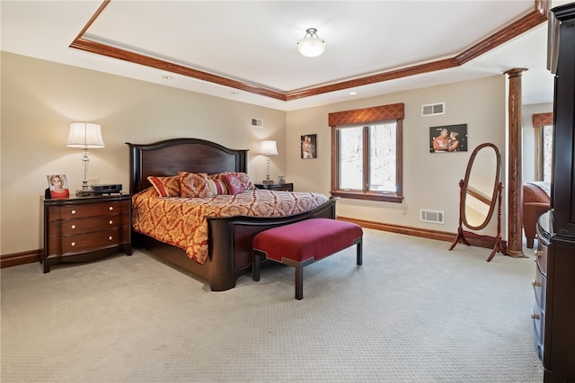 bedroom featuring crown molding, a tray ceiling, and light carpet