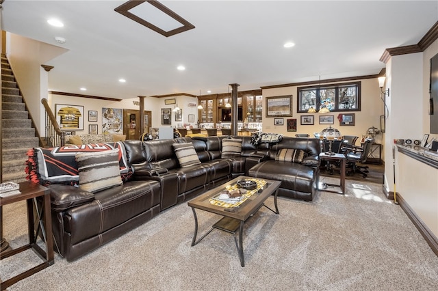 carpeted living room featuring decorative columns and ornamental molding