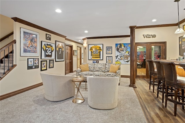 living room featuring hardwood / wood-style flooring and ornamental molding