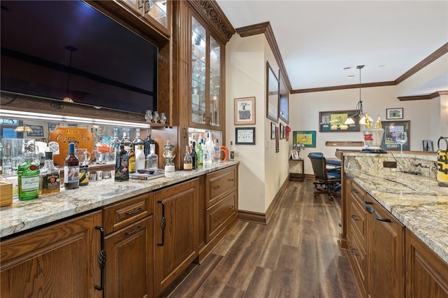 bar featuring light stone countertops, decorative light fixtures, crown molding, and dark hardwood / wood-style flooring