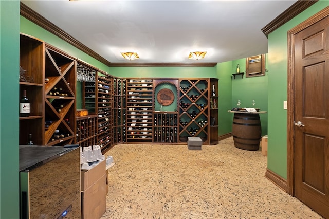 wine room featuring ornamental molding and carpet