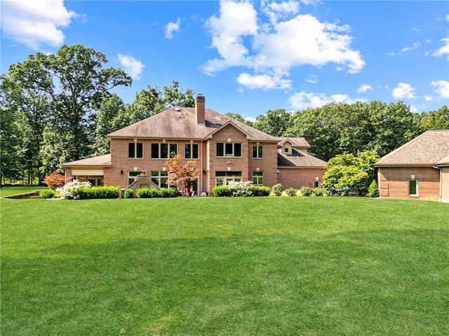 back of house with a lawn