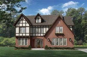 tudor-style house with a front yard