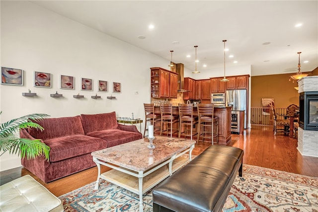 living room with wood-type flooring and a multi sided fireplace