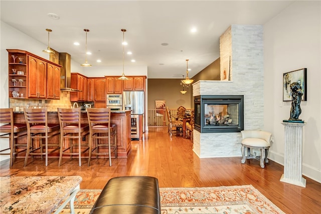 dining space featuring light hardwood / wood-style flooring and a fireplace