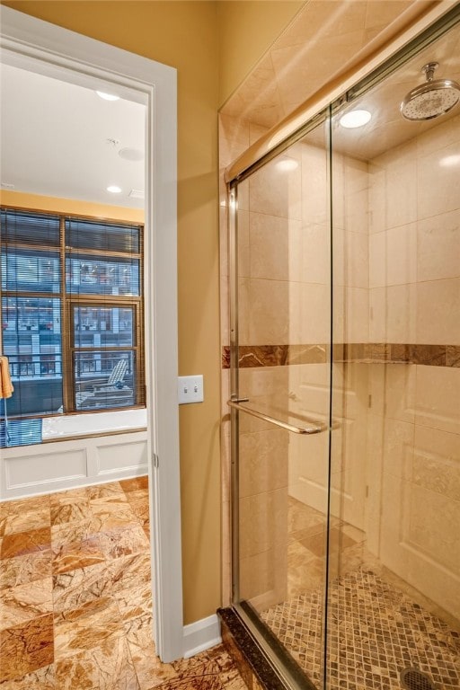 bathroom with an enclosed shower and tile flooring