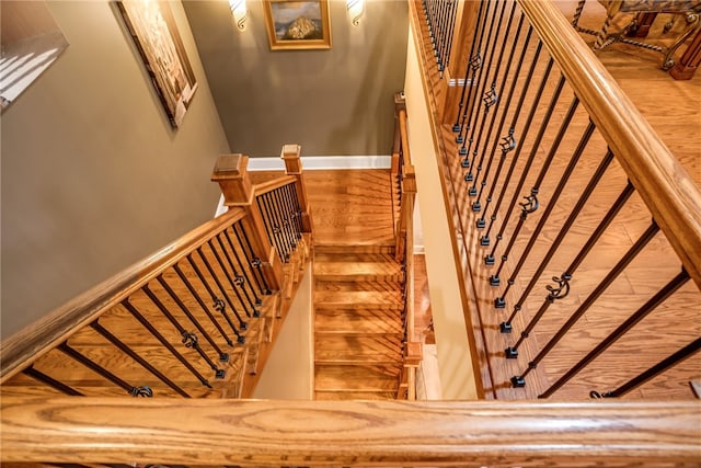 staircase with hardwood / wood-style floors