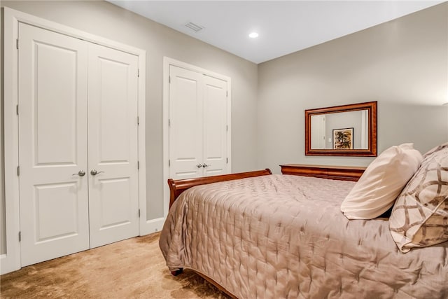 carpeted bedroom with two closets