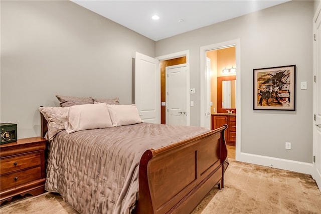 carpeted bedroom featuring ensuite bath