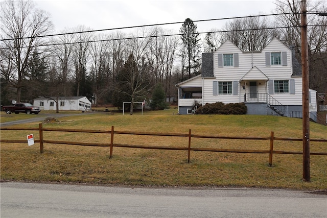 cape cod home featuring a front lawn