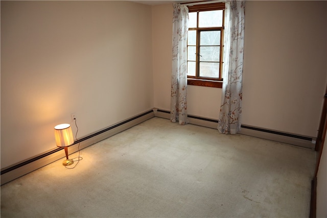 carpeted empty room featuring a baseboard heating unit