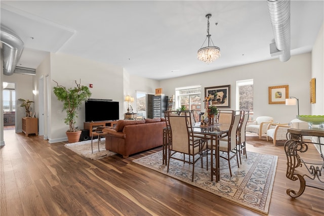 dining space featuring an inviting chandelier and dark wood-type flooring