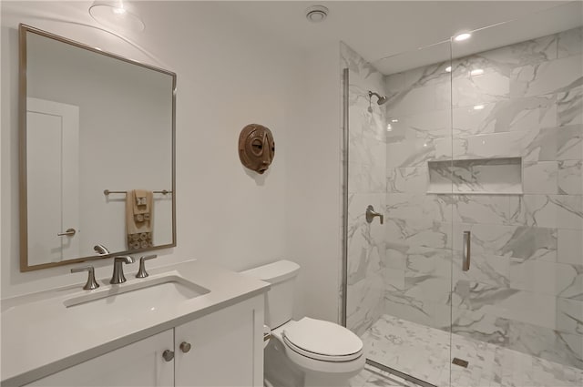 bathroom featuring vanity, an enclosed shower, and toilet