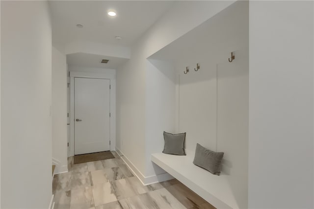 mudroom with light hardwood / wood-style flooring