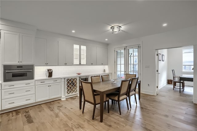 dining room featuring light wood-type flooring and plenty of natural light