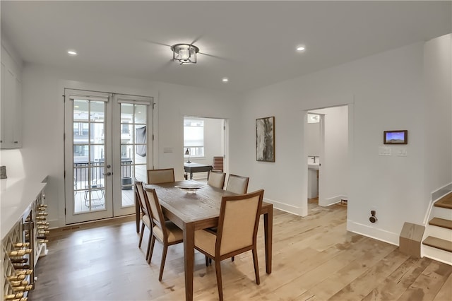 dining space featuring french doors and light wood-type flooring