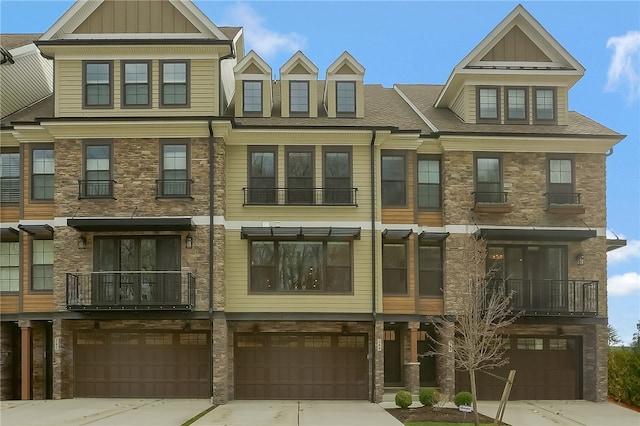 townhome / multi-family property with a balcony and a garage