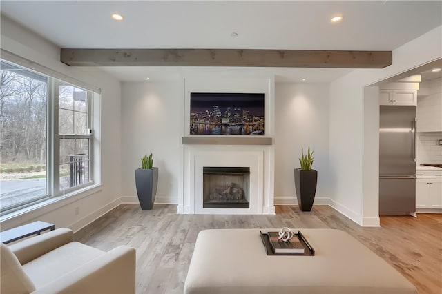 living room featuring light hardwood / wood-style floors and beamed ceiling