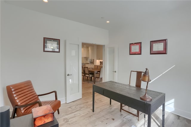 home office with light hardwood / wood-style floors