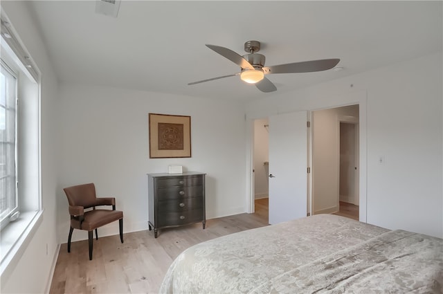 bedroom featuring multiple windows, light wood-type flooring, and ceiling fan