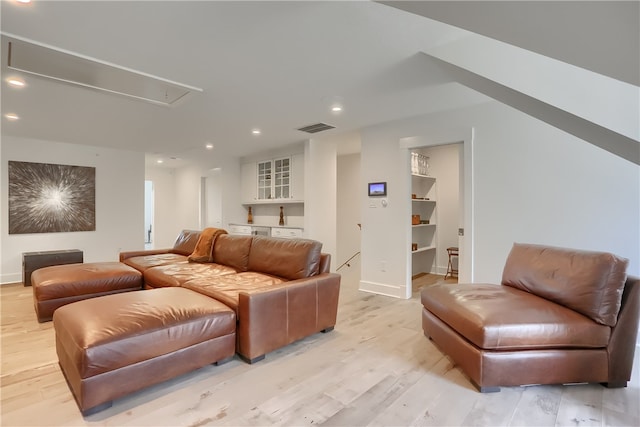 cinema room with light hardwood / wood-style floors