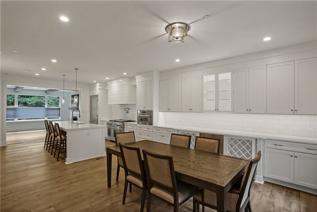 dining area featuring wood-type flooring and sink