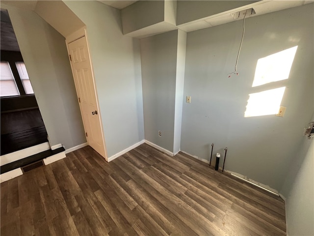 spare room with dark wood-type flooring