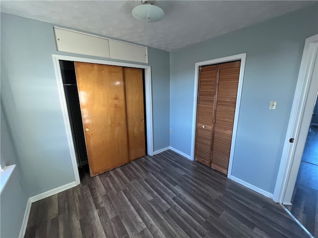 unfurnished bedroom featuring dark wood-type flooring