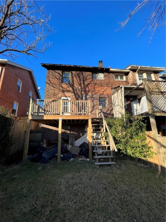 back of house featuring a yard and a wooden deck