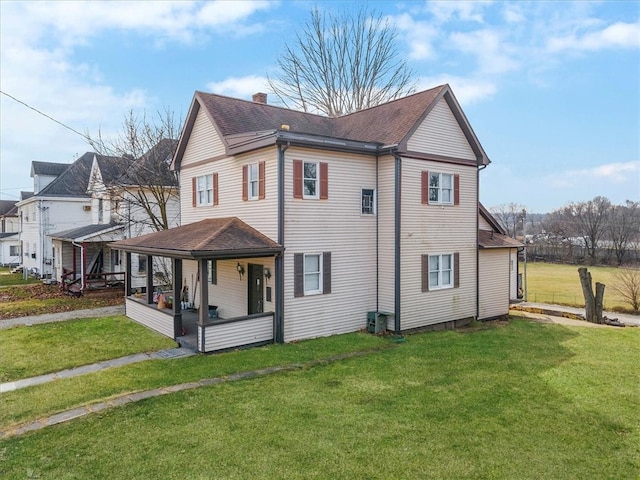 exterior space featuring a yard, central AC unit, and a porch