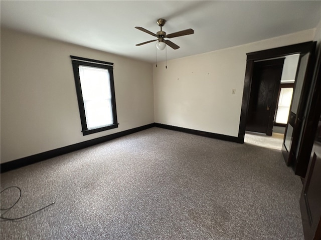 empty room with ceiling fan and carpet floors