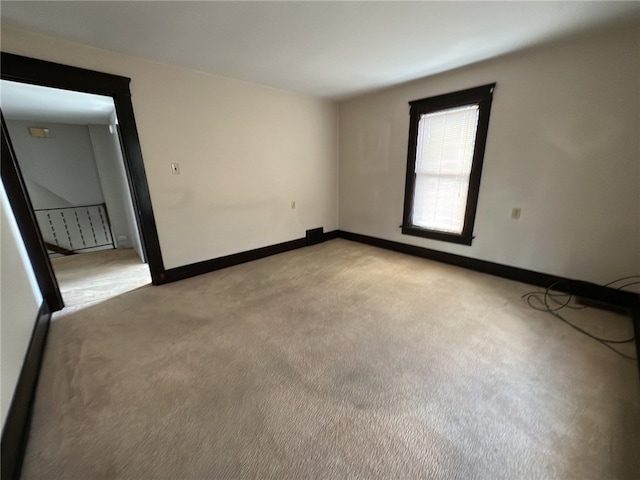 spare room with light colored carpet