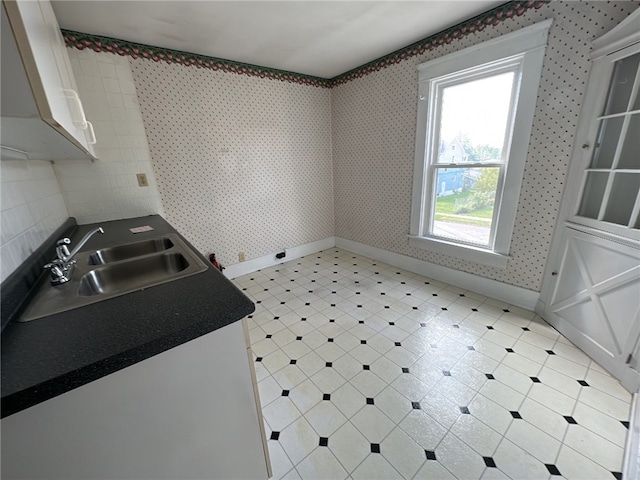 kitchen with white cabinetry and sink