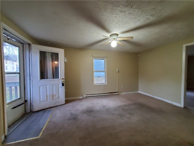 spare room with carpet, ceiling fan, a textured ceiling, and a baseboard heating unit