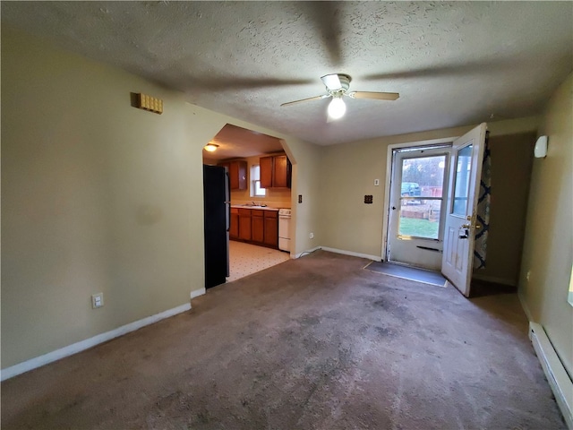 interior space featuring ceiling fan, light carpet, a textured ceiling, and a baseboard radiator