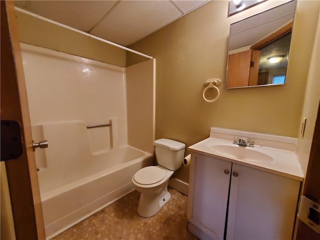 full bathroom featuring vanity, toilet, bathing tub / shower combination, and a drop ceiling