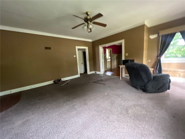 unfurnished living room featuring crown molding, carpet floors, and ceiling fan