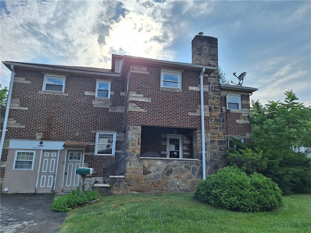 rear view of house featuring a lawn