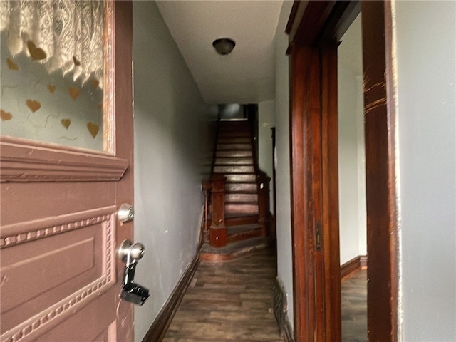 corridor with lofted ceiling and dark hardwood / wood-style flooring