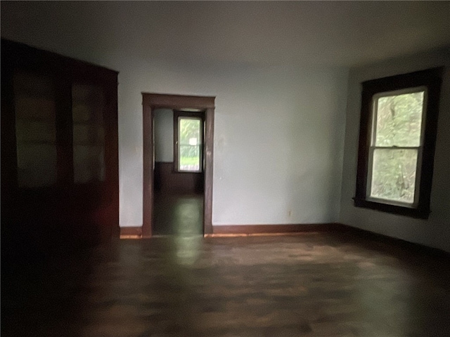 spare room featuring dark wood-type flooring